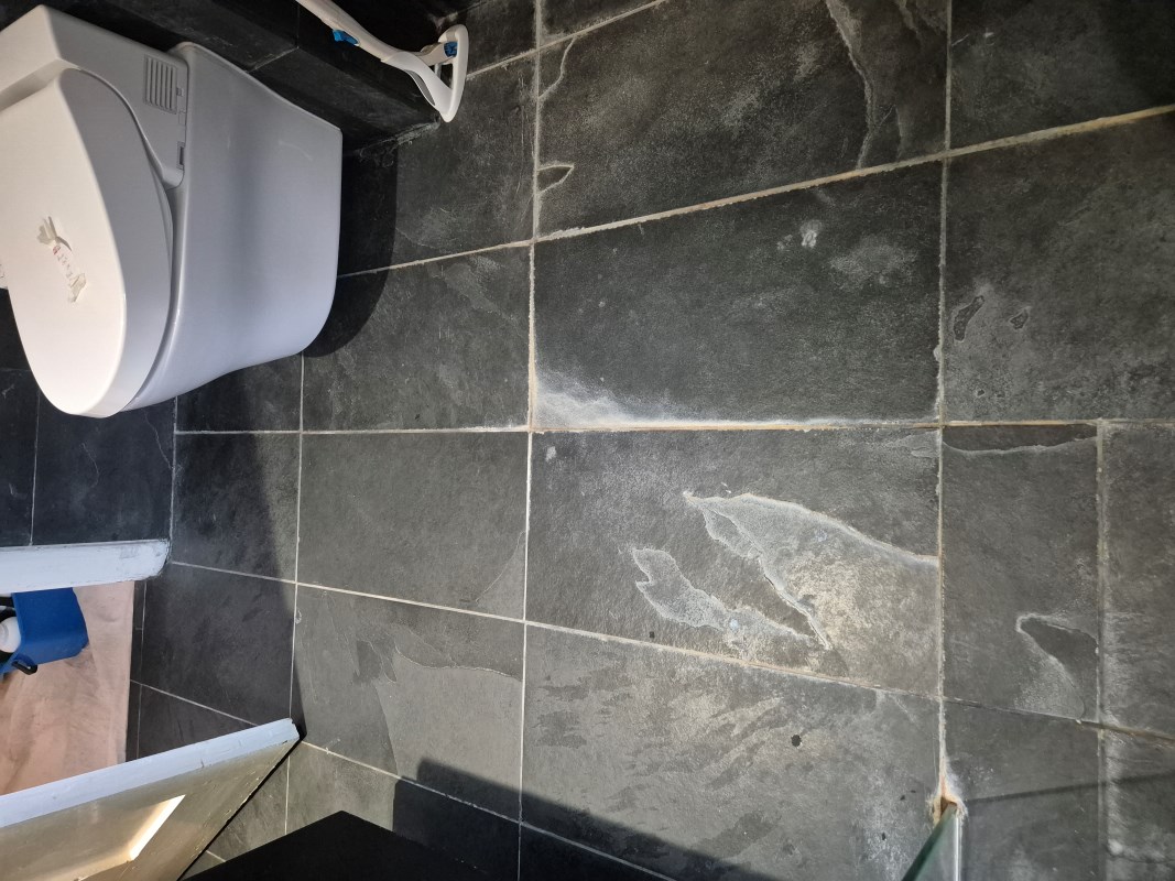 Limescale Stained Slate Tiled Bathroom Floor Before Cleaning Wimbledon